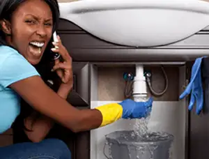 Emergency plumbing repair for a leaking sink drain under a bathroom vanity in Mesa, AZ