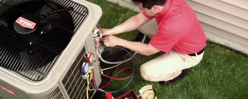 HVAC technician servicing an outdoor air conditioner unit in Mesa, AZ