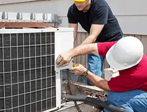 HVAC technicians repairing an outdoor AC unit on a rooftop in Mesa, AZ
