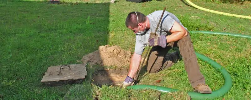 Septic pumping technician servicing a residential septic tank in Mesa, AZ